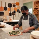 A chef preparing a pizza in Marzano