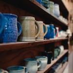 A row of handmade mugs made by a local ceramic artist.