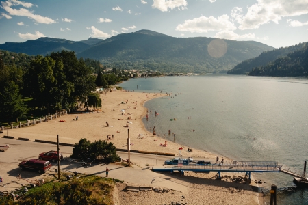 The beach at Lakeside Park in Nelson, BC busy with people.