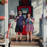 Two people standing outside of Nelson Brewing Company smiling.