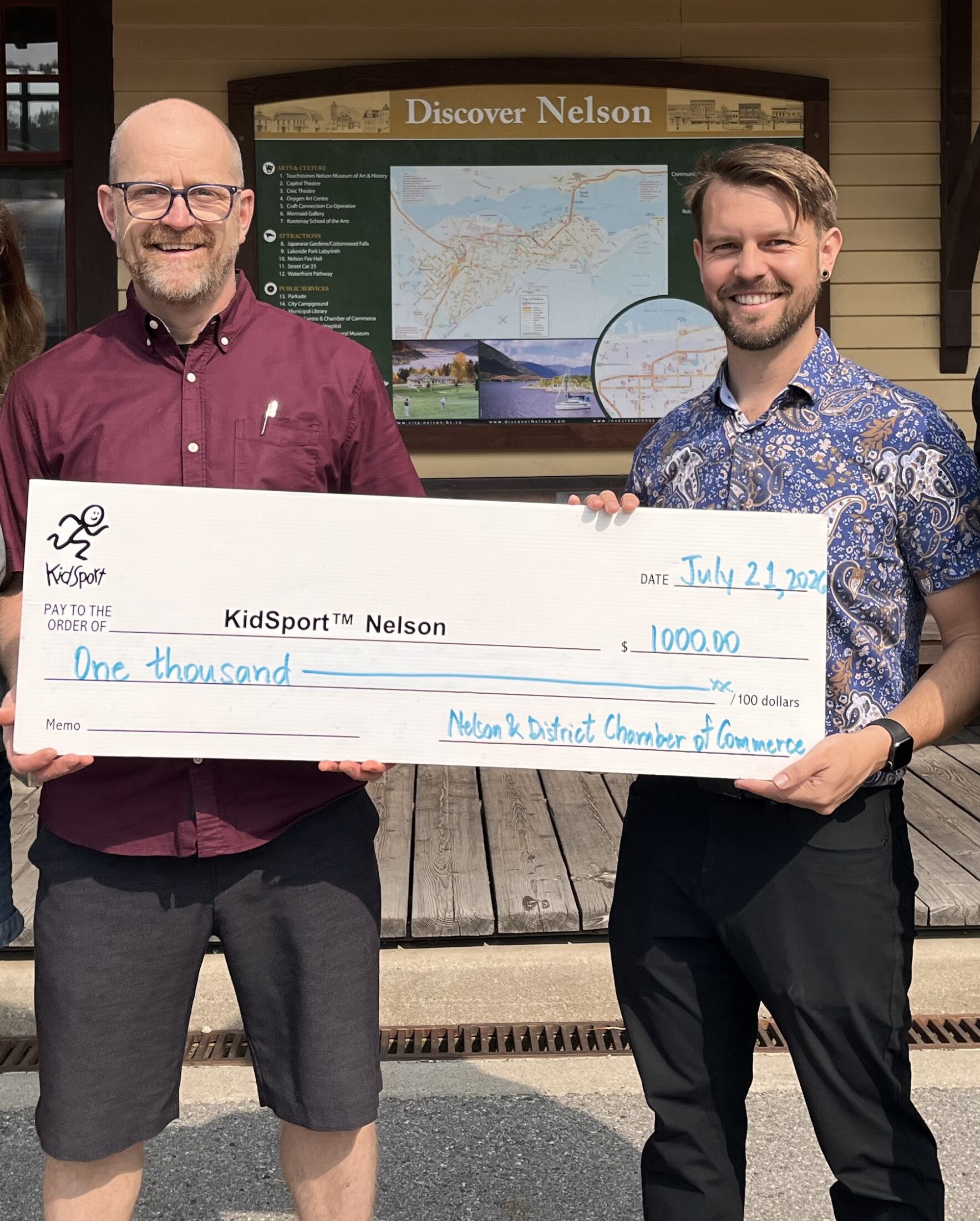 Matt Popp (left) provides a donation to the local KidSport group.